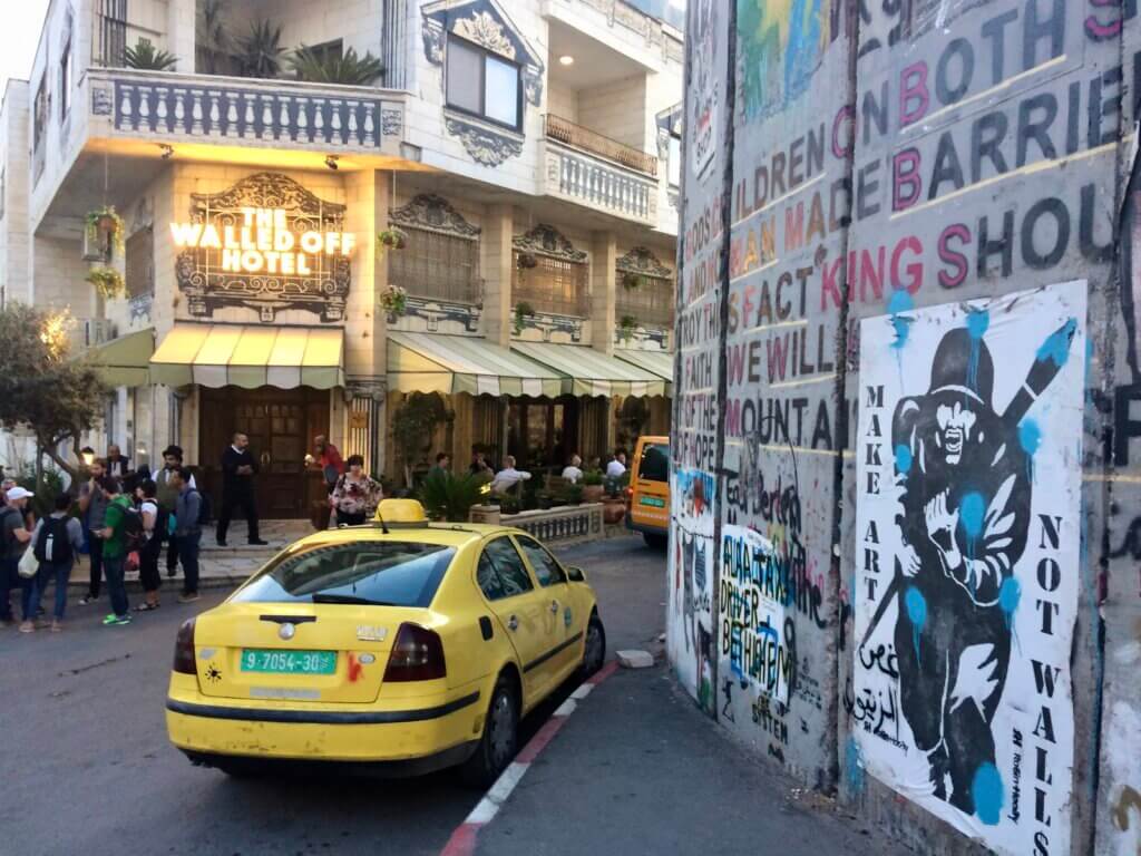 Banksy's Walled Off Hotel, barrier wall, yellow taxi